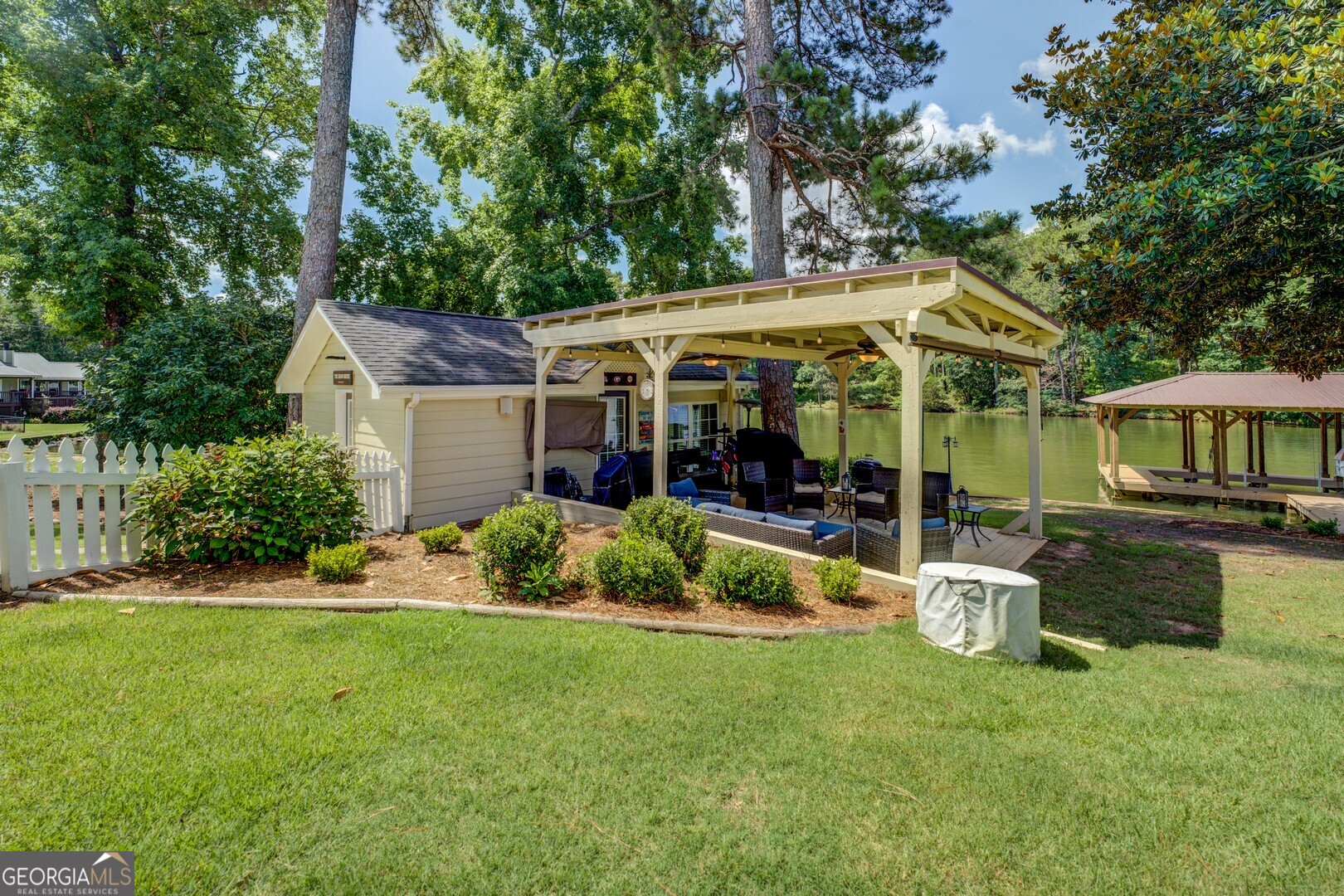 8950 Jackson Lake Road Monticello, GA 31064 - Photo 85 of 88 a view of a house with a backyard and a patio