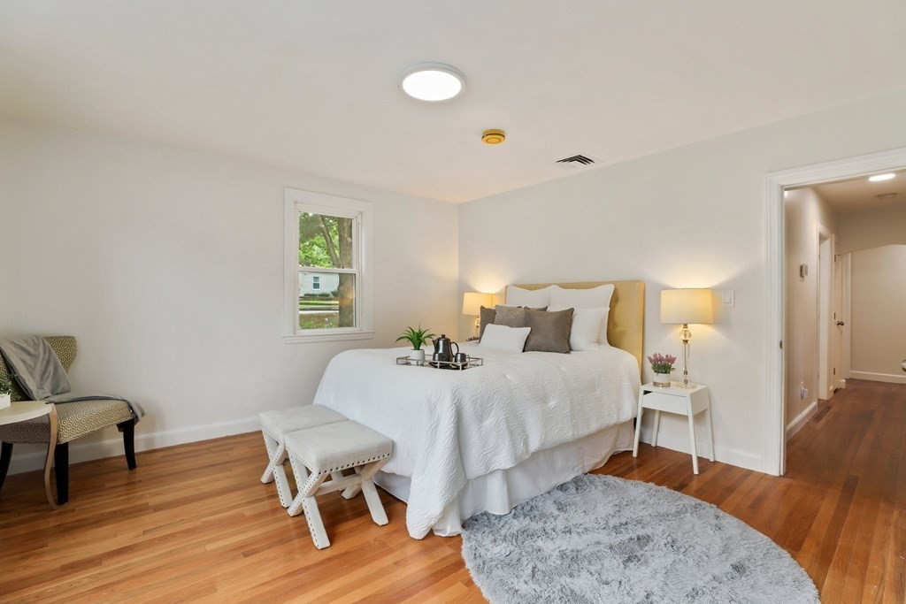 1177 Bay Road Sharon, MA 02067 - Photo 13 of 27 a bedroom with a bed and wooden floor