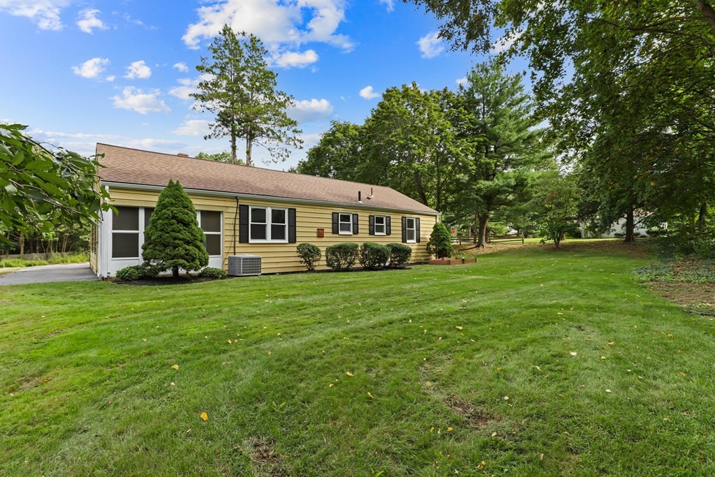 1177 Bay Road Sharon, MA 02067 - Photo 23 of 27 a front view of a house with a yard and green space