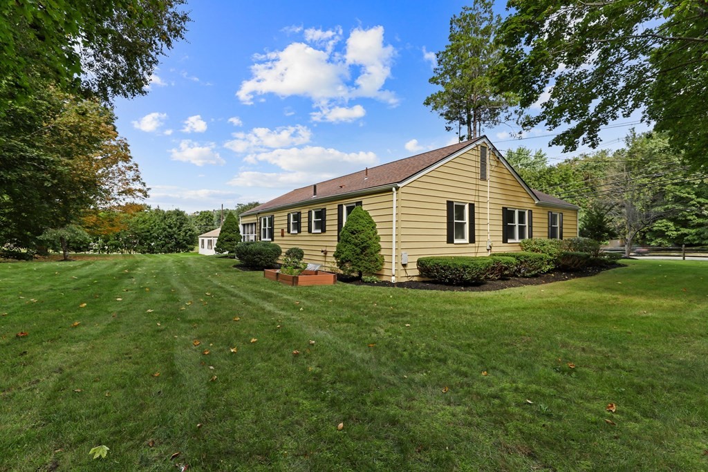 1177 Bay Road Sharon, MA 02067 - Photo 24 of 27 a front view of a house with a yard