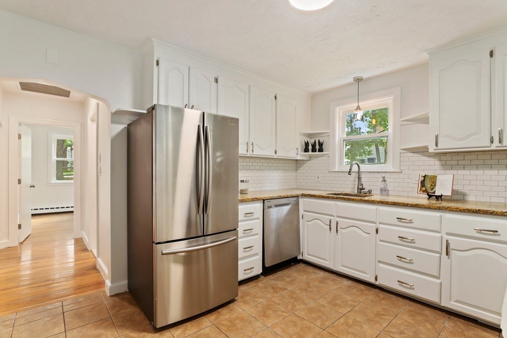 1177 Bay Road Sharon, MA 02067 - Photo 7 of 27 a kitchen with stainless steel appliances a refrigerator sink and cabinets
