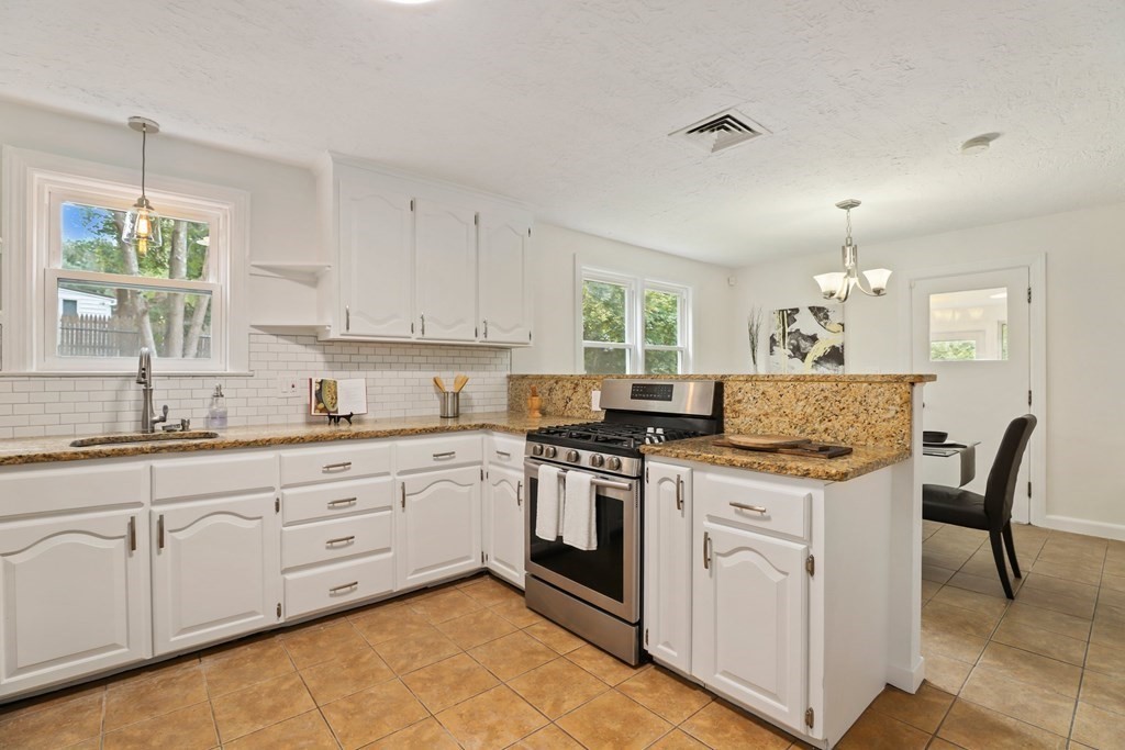 1177 Bay Road Sharon, MA 02067 - Photo 8 of 27 a kitchen with a stove sink and cabinets