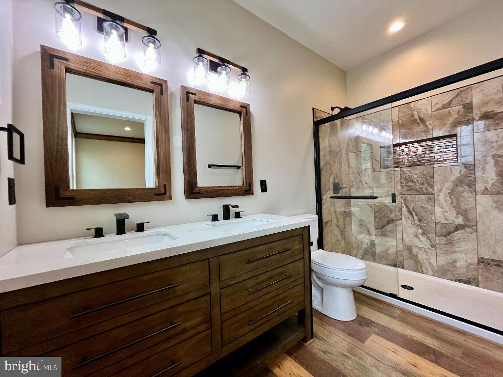 6 Antioch Road Luray, VA 22835 - Photo 21 of 39 a bathroom with a double vanity sink toilet mirror and shower