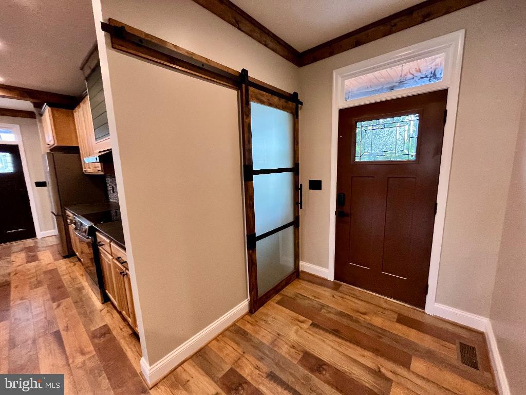 6 Antioch Road Luray, VA 22835 - Photo 26 of 39 a view of a hallway to a room with wooden floor and furniture