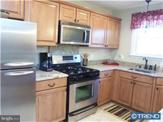 1130 Musket Road Newark, DE 19713 - Photo 5 of 12 a kitchen with granite countertop a sink stove and microwave