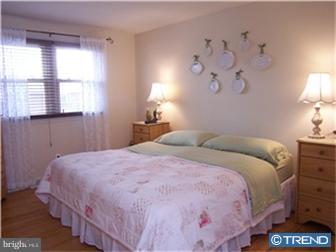 1130 Musket Road Newark, DE 19713 - Photo 7 of 12 a bedroom with a bed and a lamp on dresser