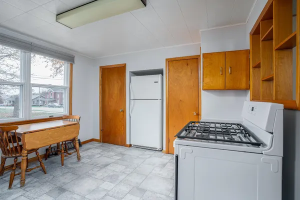a kitchen that has a stove and a table in it