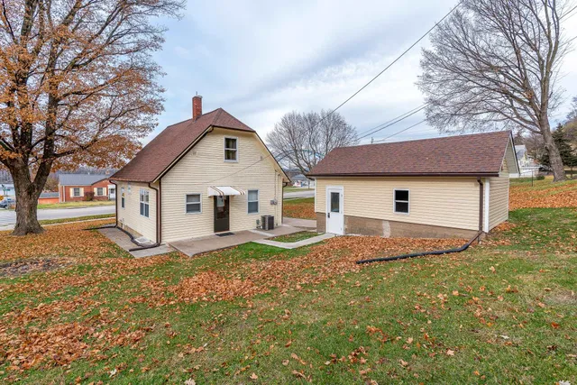 a front view of house with yard and trees