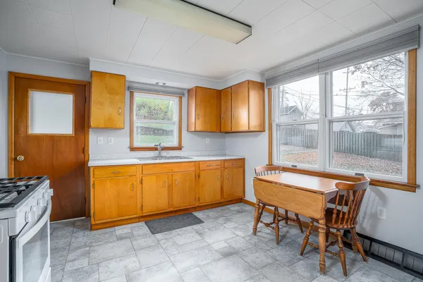 a backyard of a house with table and chairs