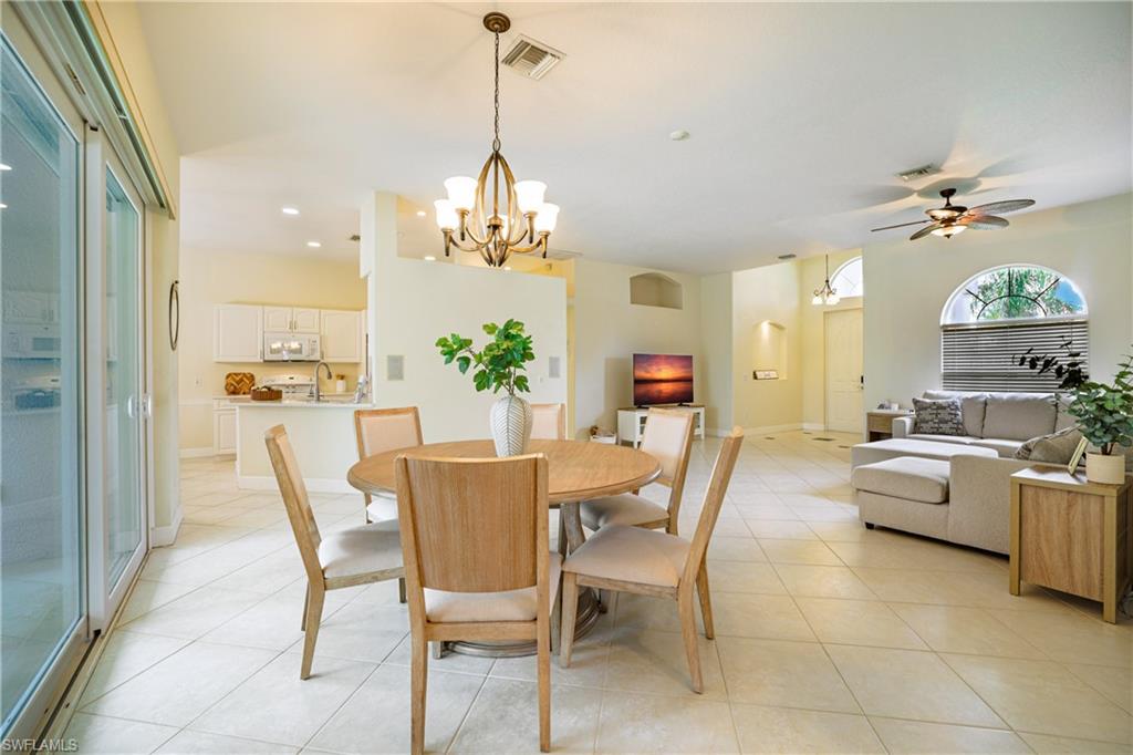 5235 Malvern Court Naples, FL 34112 - Photo 9 of 28 a view of a dining room kitchen furniture and a chandelier