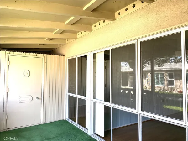 a view of entryway with a big room and windows