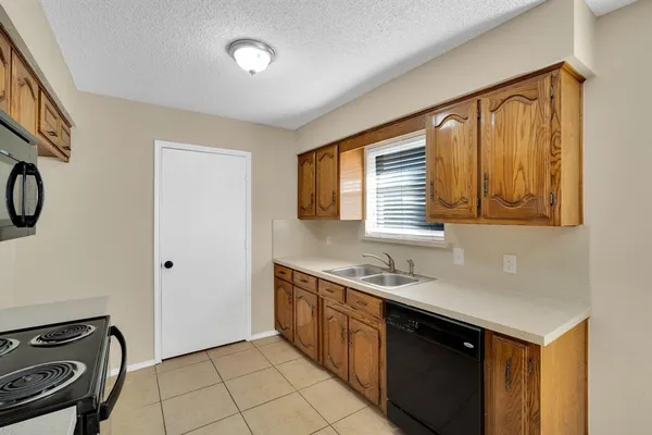 a kitchen with stainless steel appliances a sink stove and cabinets