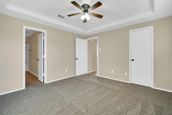 a view of an empty room and a ceiling fan