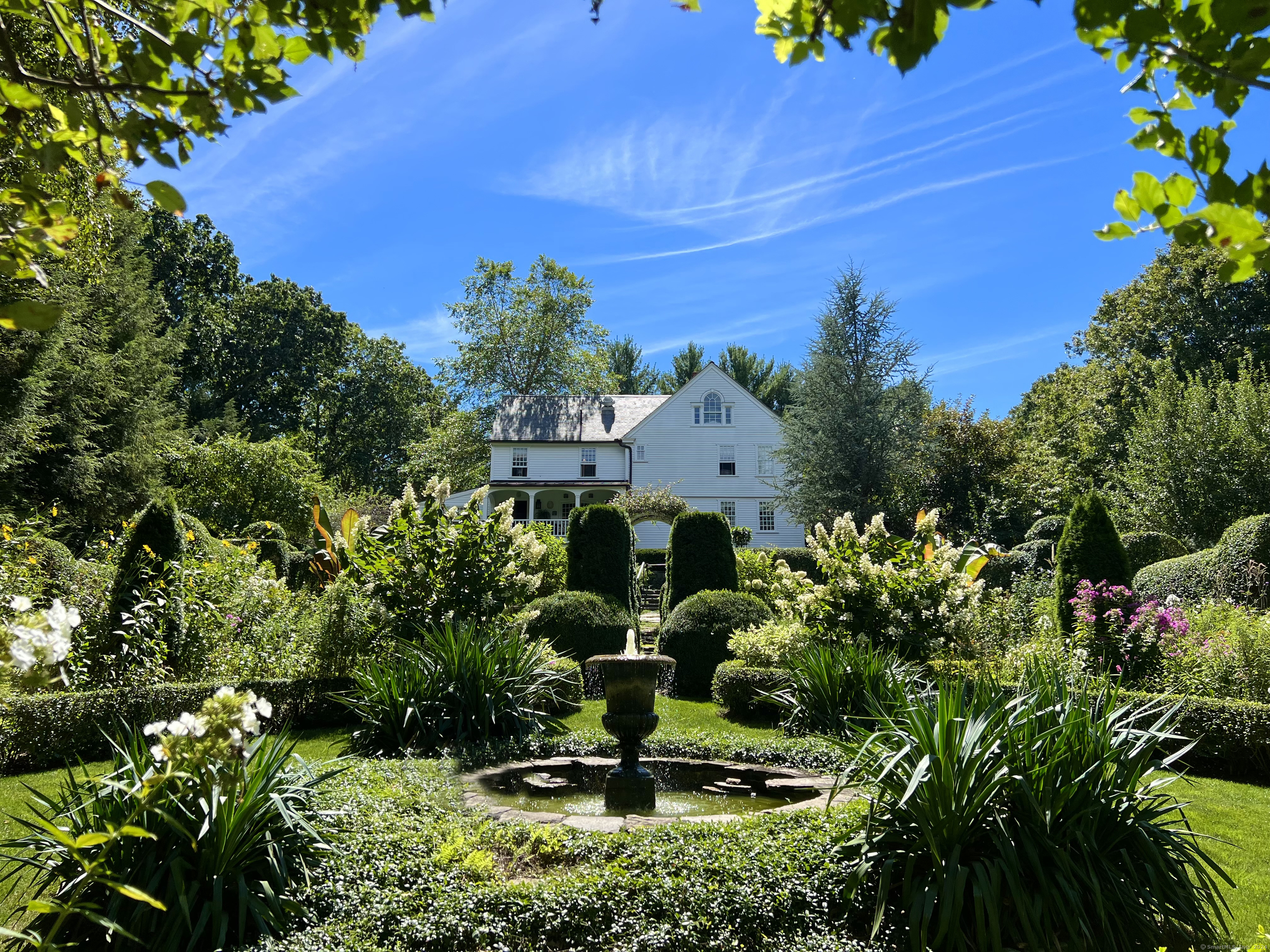 a view of a garden with a house