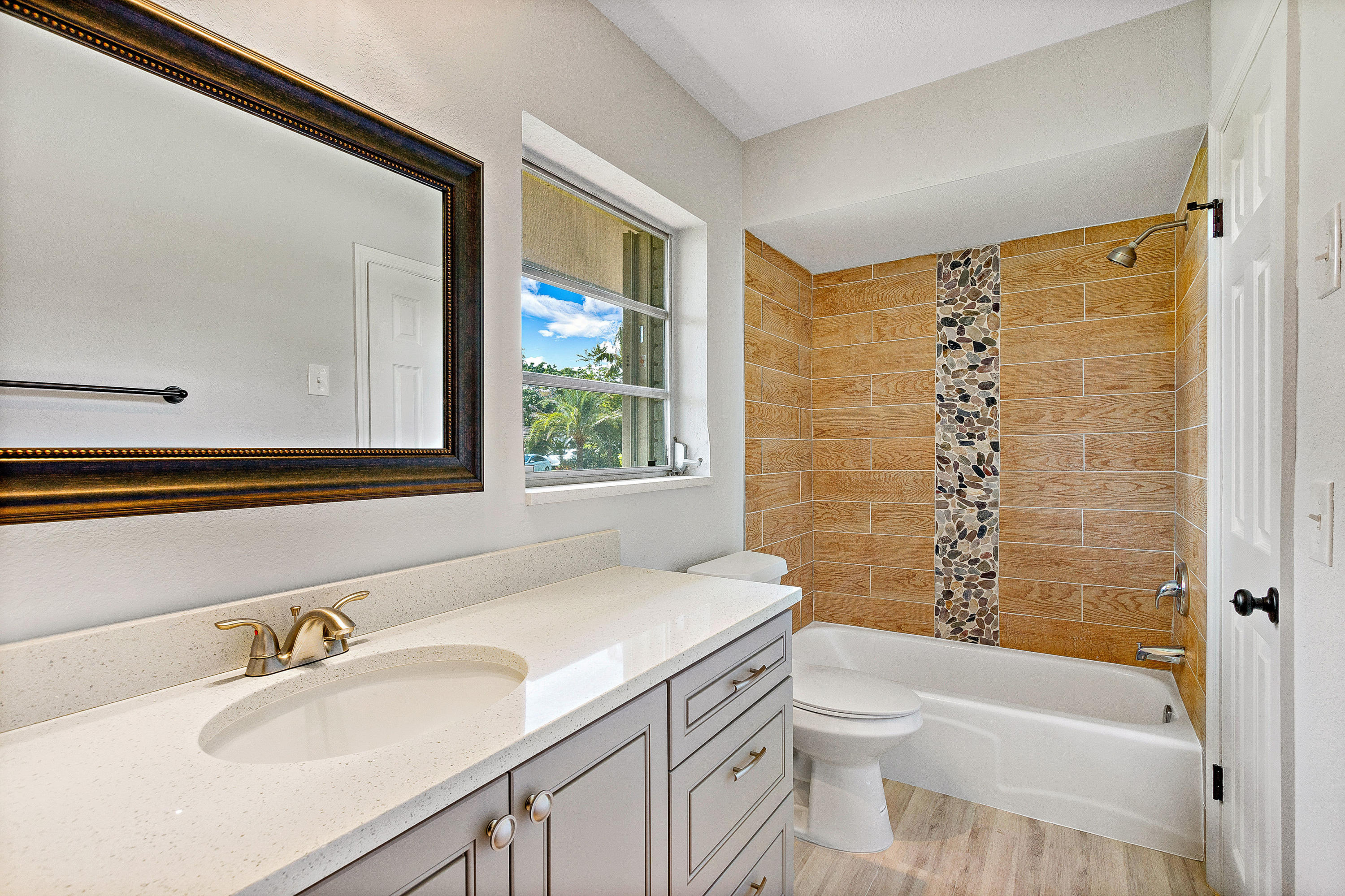 871 Northwest 7th Street Boca Raton, FL 33486 - Photo 15 of 21 a bathroom with a granite countertop sink toilet and shower