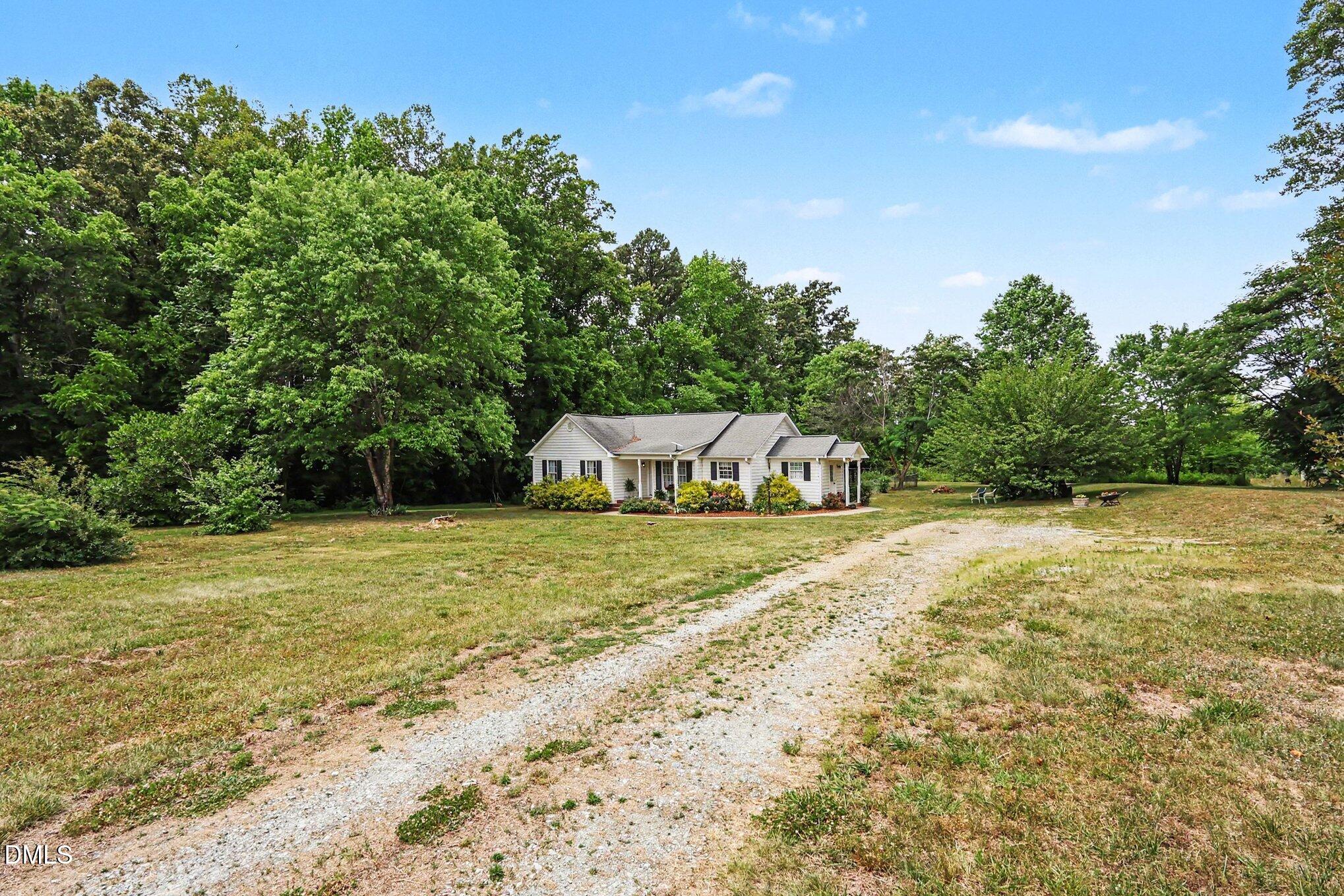 1750 Tom Oakley Road Timberlake, NC 27583 - Photo 26 of 31 a front view of a house with a yard and trees