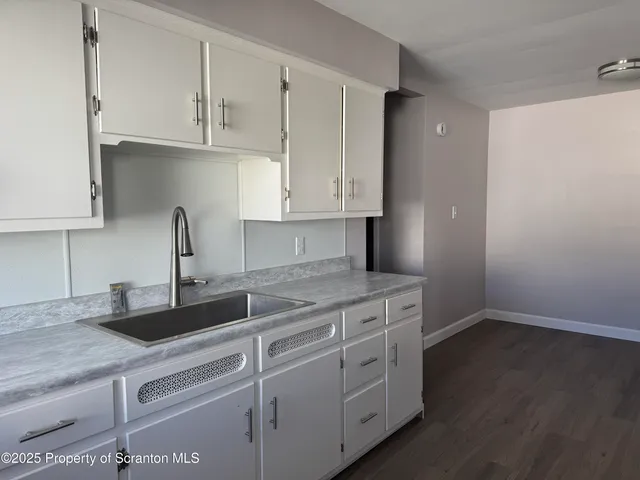 a kitchen with appliances cabinets and a sink