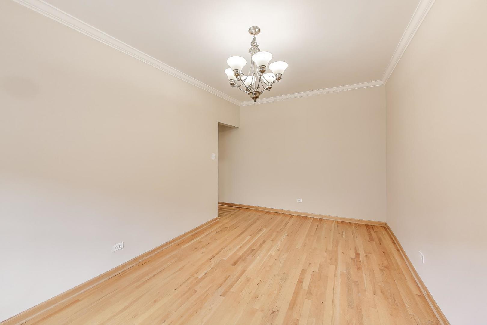 243 Washington Boulevard, Unit 3A Oak Park, IL 60302 - Photo 16 of 21 a view of room with wooden floor and chandelier