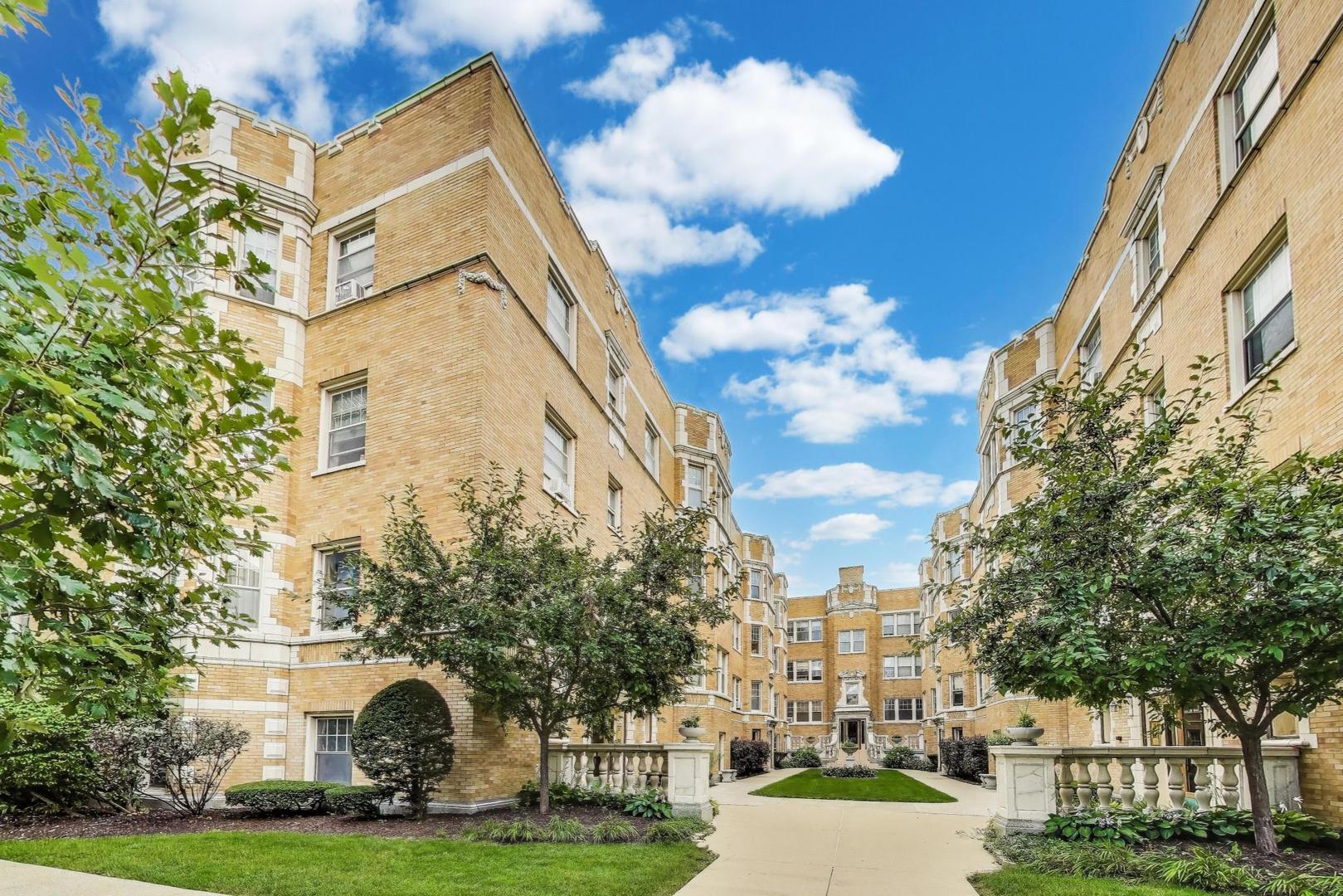 243 Washington Boulevard, Unit 3A Oak Park, IL 60302 - Photo 2 of 21 a view of a white building with a big yard and large trees