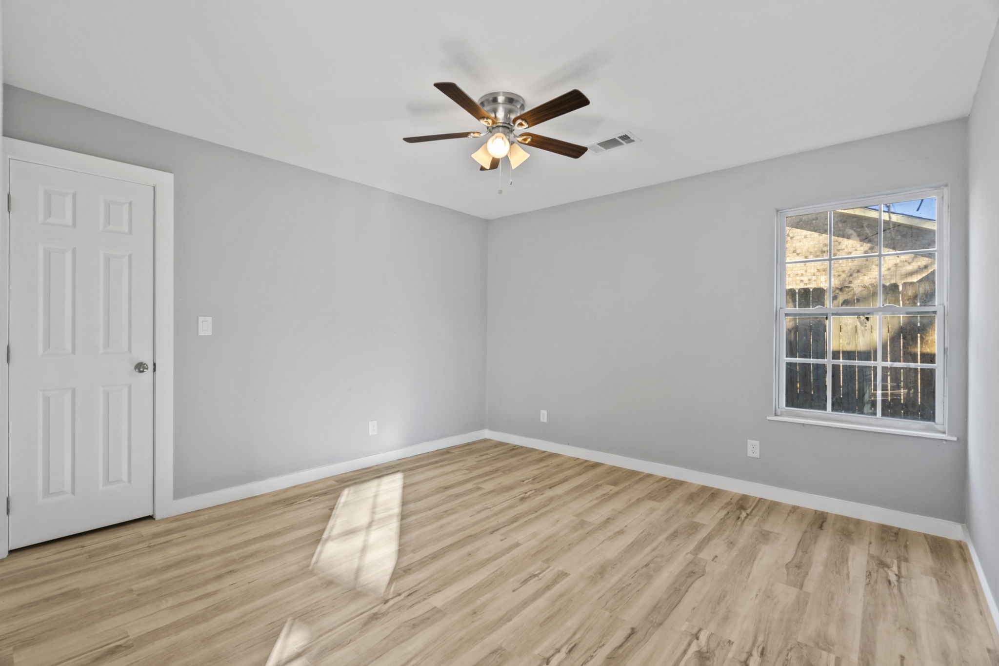 1740 6th Street Hempstead, TX 77445 - Photo 8 of 21 a view of empty room with wooden floor and fan