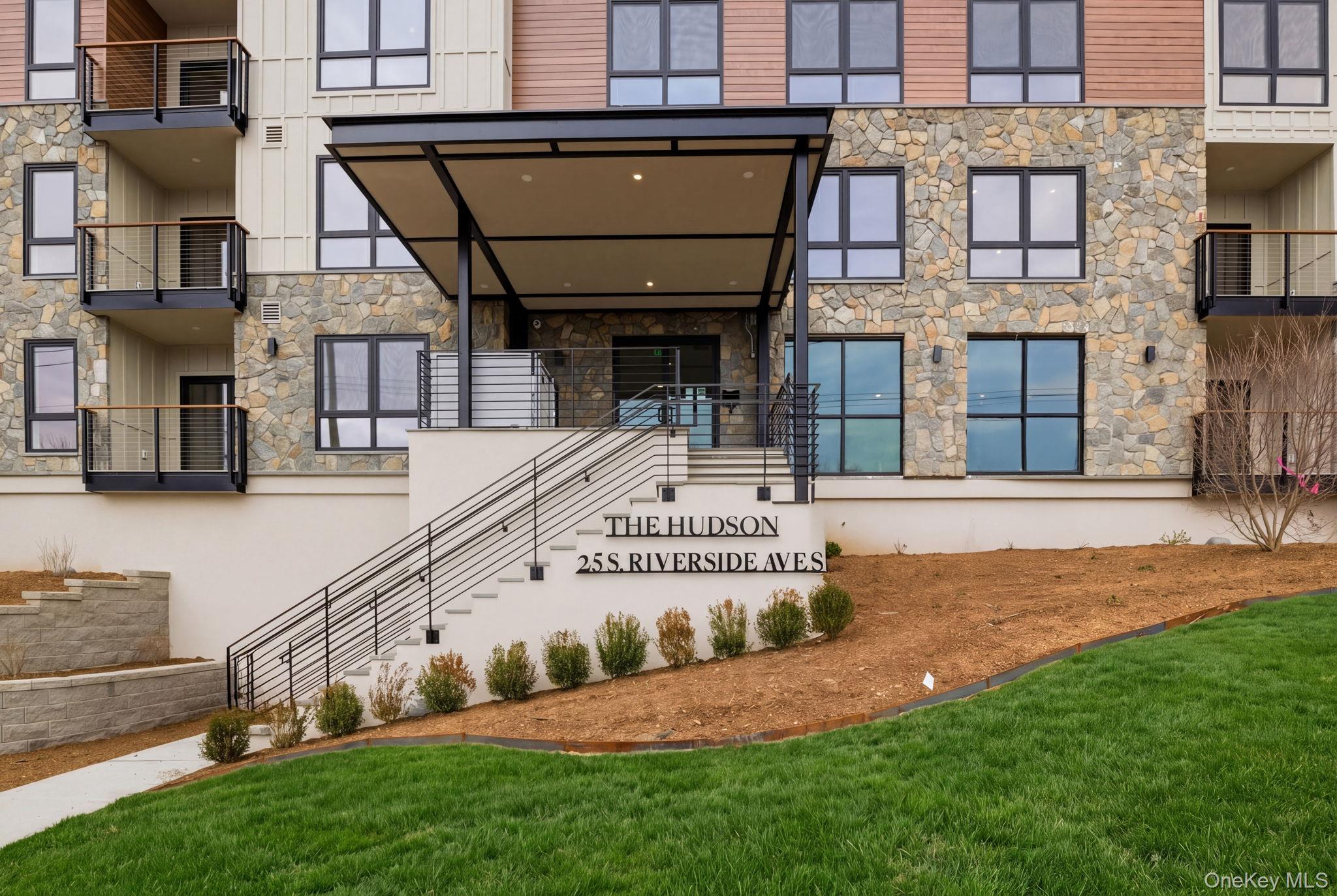 a view of a house with a small yard and plants