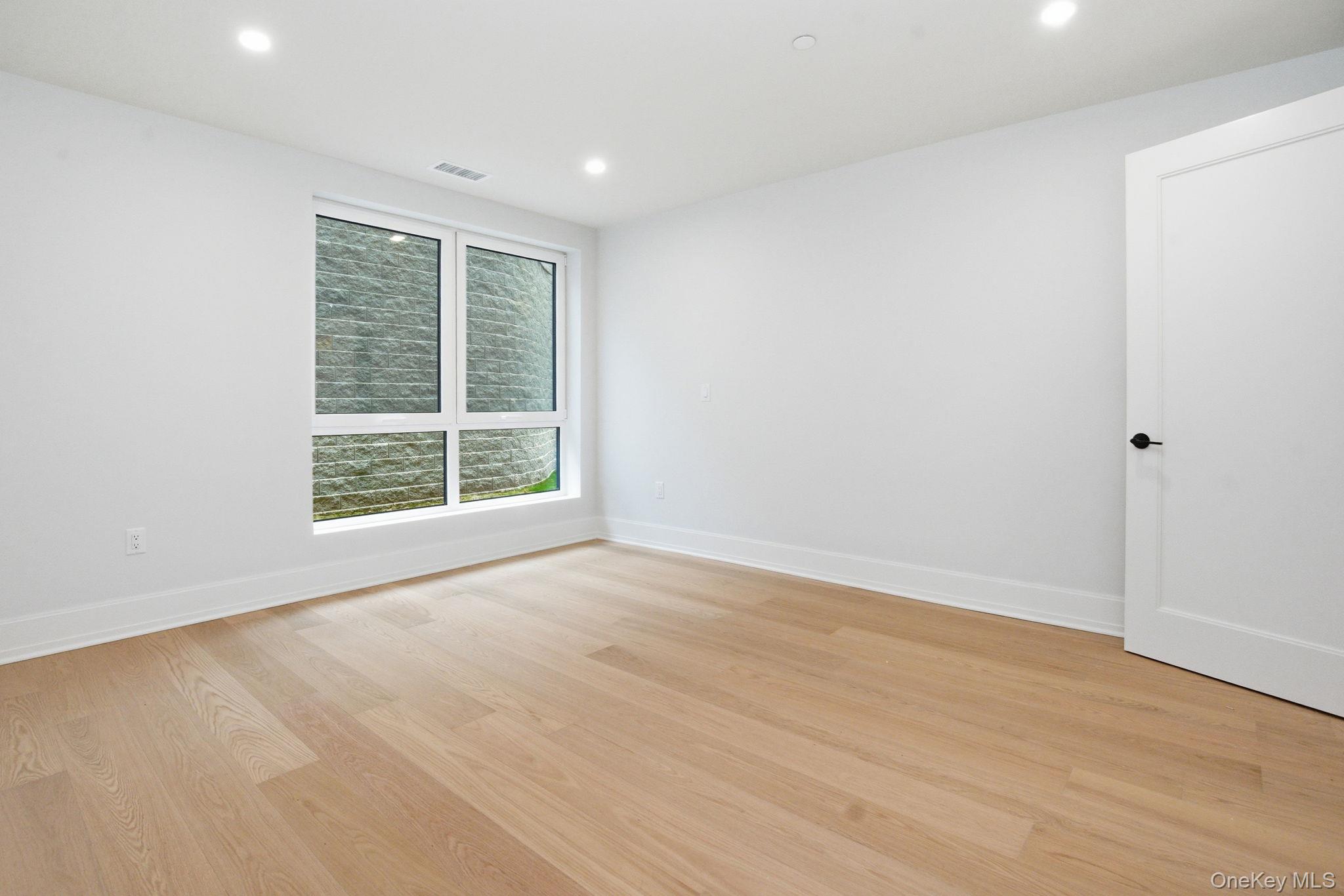 25 South Riverside Avenue, Unit 107 Croton-on-Hudson, NY 10520 - Photo 13 of 42 an empty room with wooden floor and windows