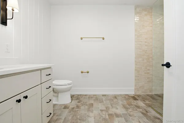 a bathroom with a toilet a sink a shower curtain