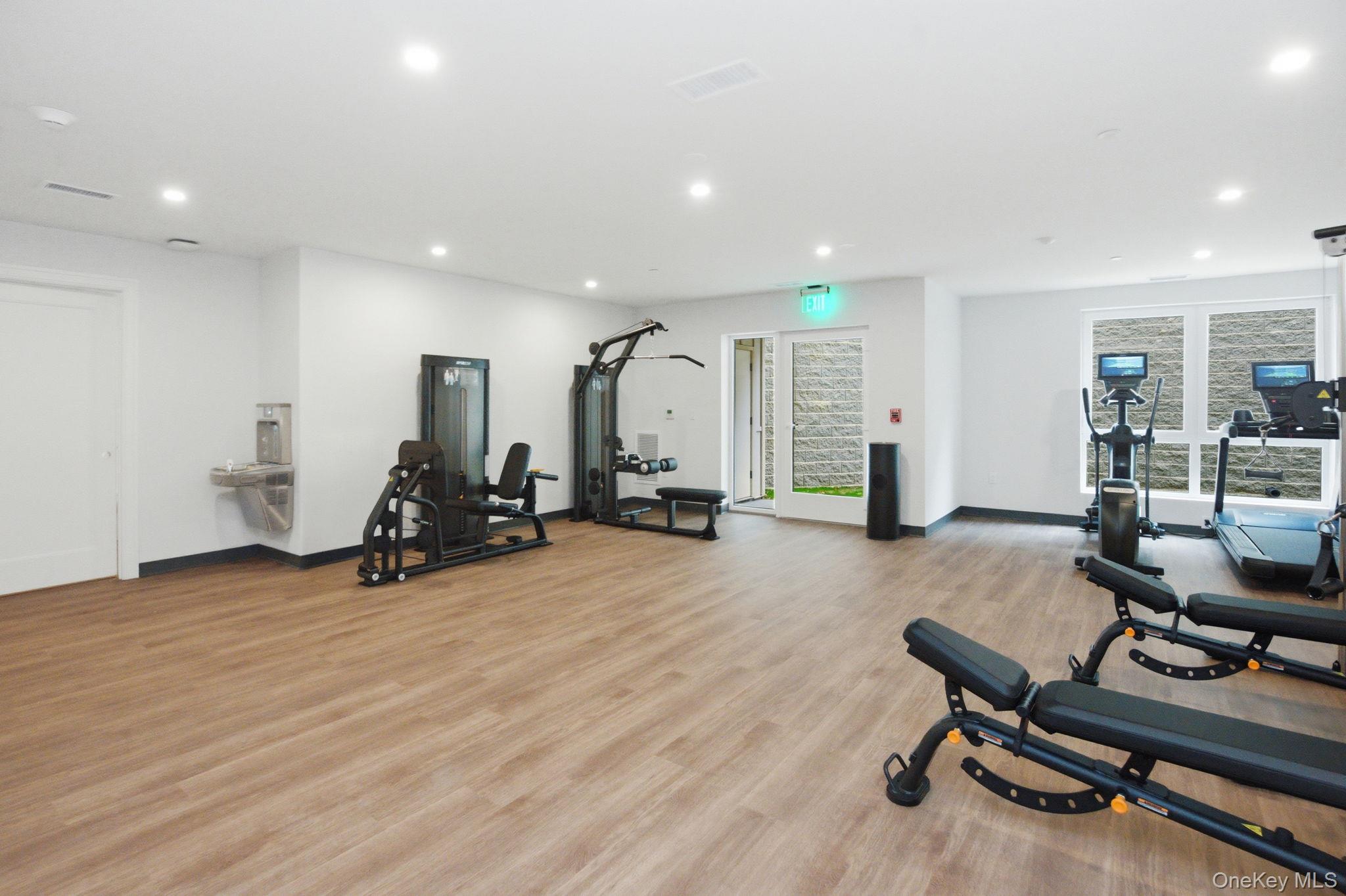 25 South Riverside Avenue, Unit 107 Croton-on-Hudson, NY 10520 - Photo 21 of 42 a view of a room with gym equipment and wooden floor