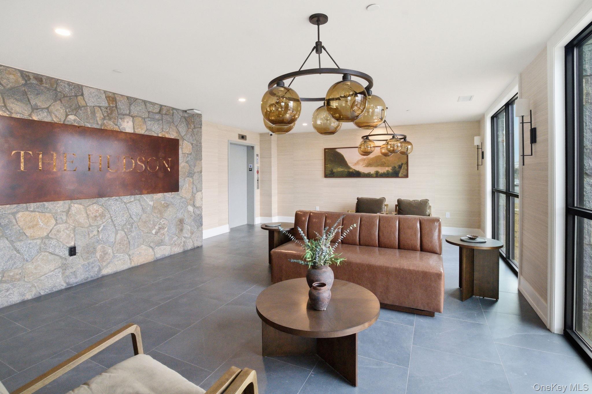 25 South Riverside Avenue, Unit 107 Croton-on-Hudson, NY 10520 - Photo 29 of 42 a living room with furniture and a flat screen tv