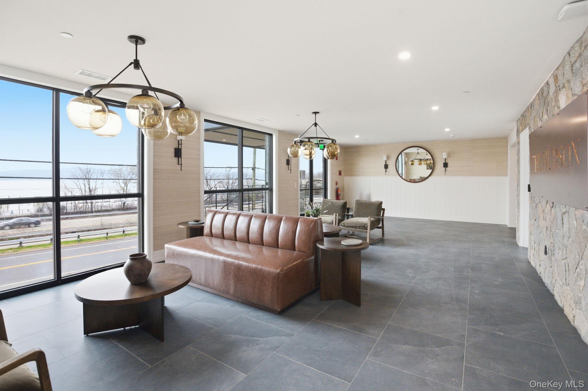 25 South Riverside Avenue, Unit 107 Croton-on-Hudson, NY 10520 - Photo 30 of 42 a living room with furniture and a floor to ceiling window