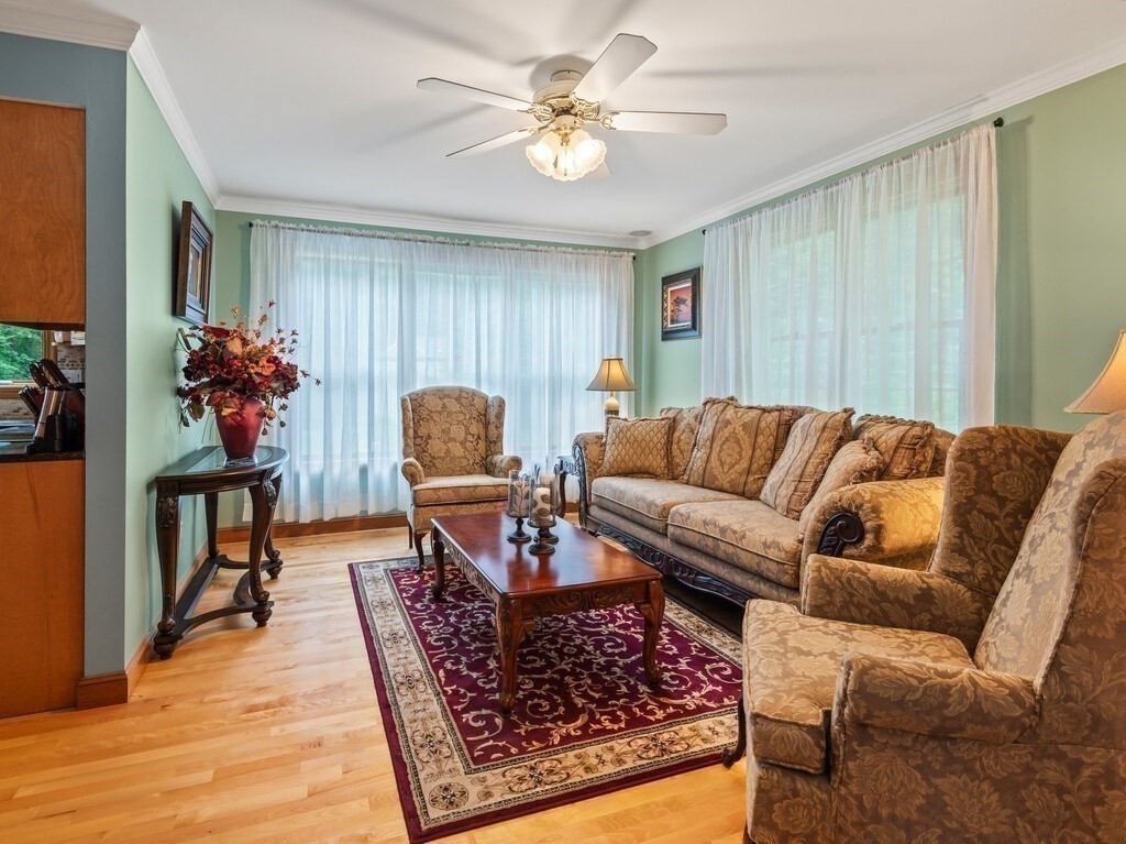9 Santom Street Auburn, MA 01501 - Photo 15 of 42 a living room with furniture and a chandelier