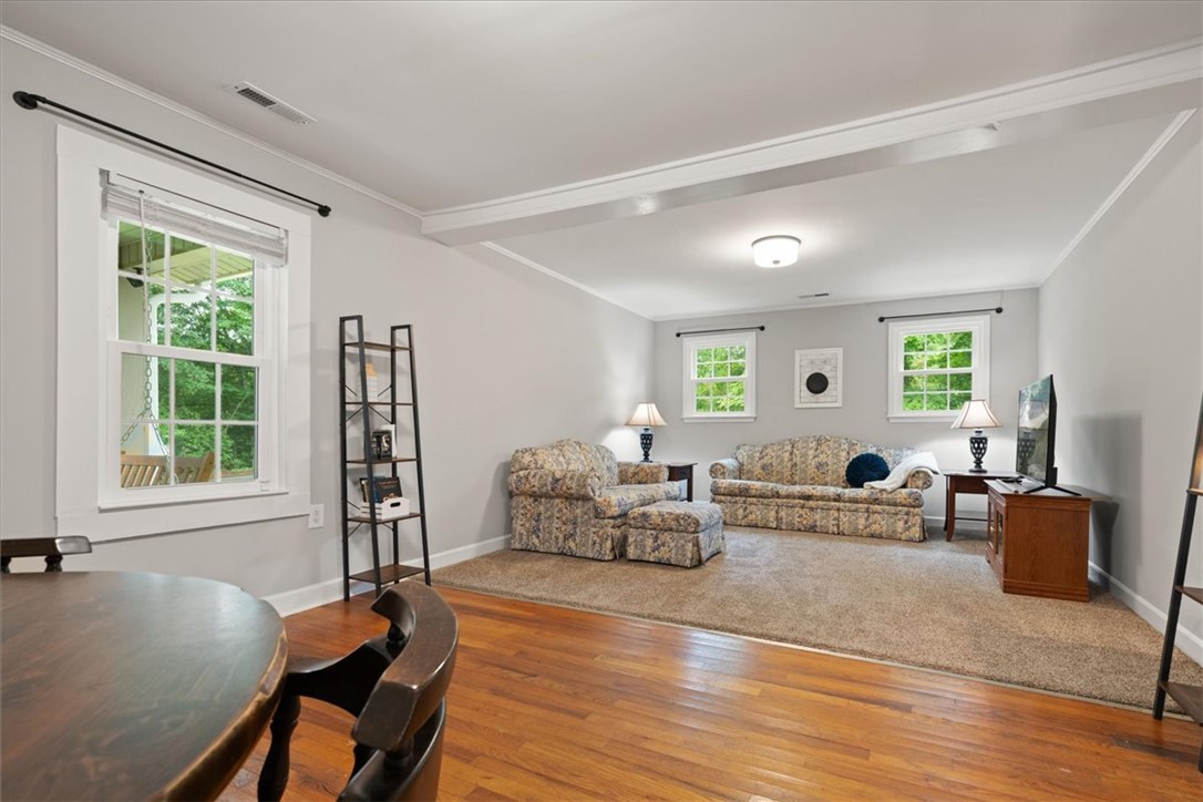 174 Holliday Road Six Mile, SC 29682 - Photo 5 of 49 Original Hardwood flooring in the dining area seamlessly transitions to a carpeted living room creating beautiful and comfortable spaces