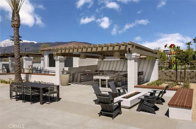 a view of a patio with table and chairs with wooden floor and fence