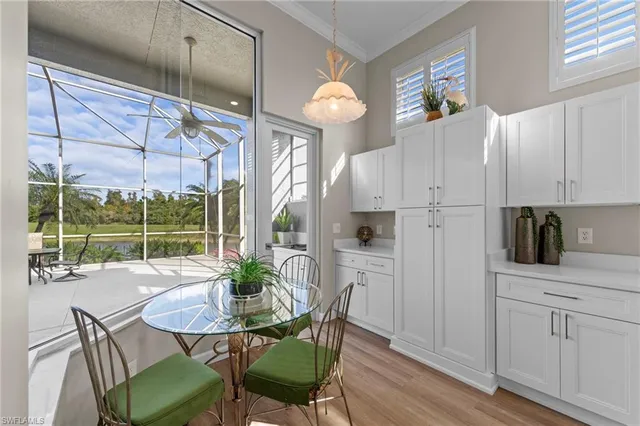 a kitchen with a table chairs and entryway