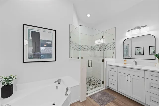 a bathroom with a double vanity sink mirror and shower