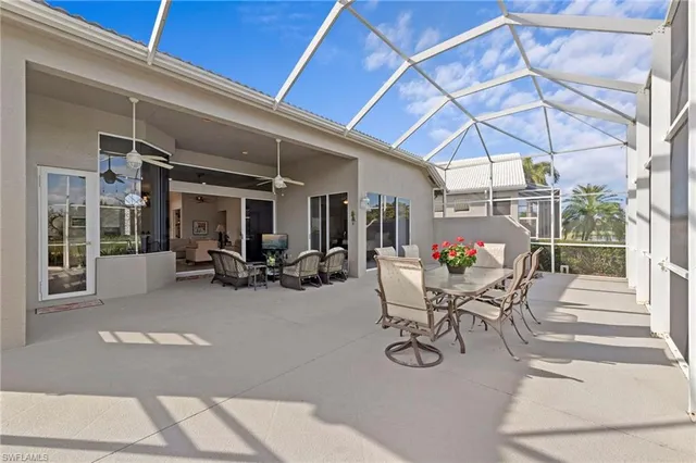 a view of a patio with table and chairs under an umbrella