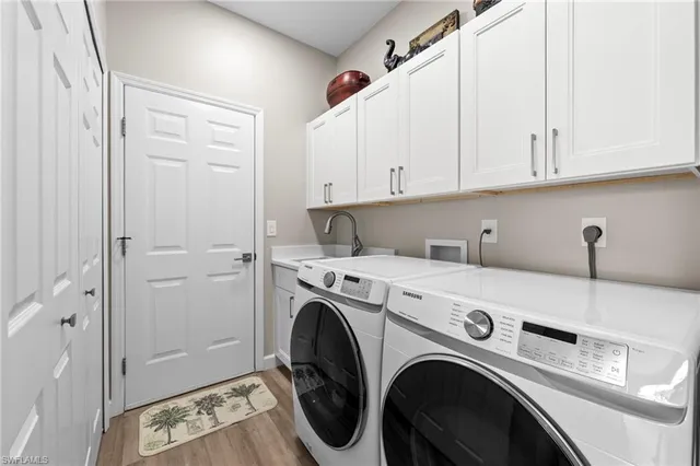 a view of washer and dryer with kitchen in the background
