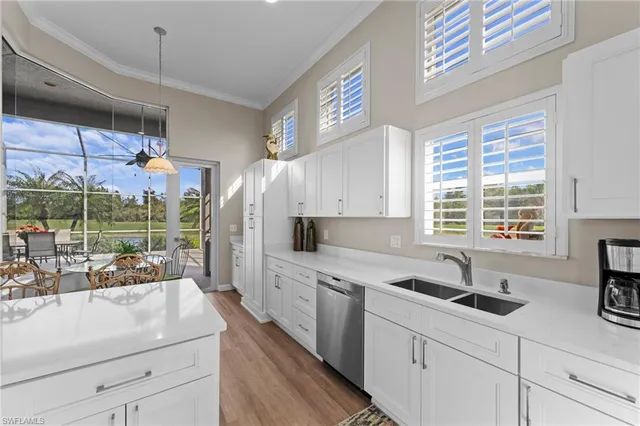 a kitchen with a sink window and cabinets