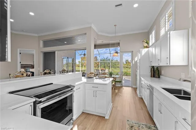 a kitchen with a sink stove and cabinets