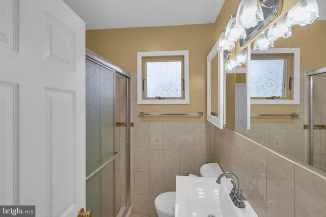 a bathroom with a toilet sink and shower