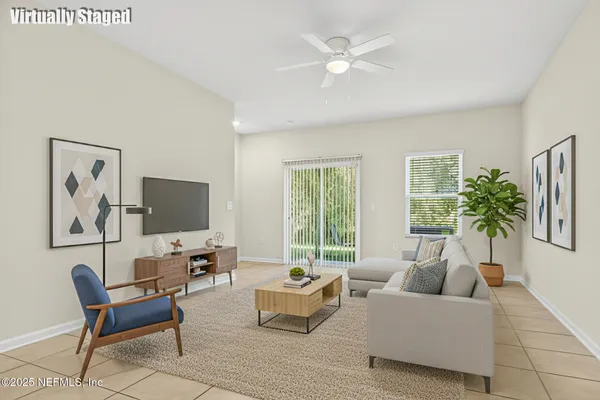a view of an empty room and ceiling fan