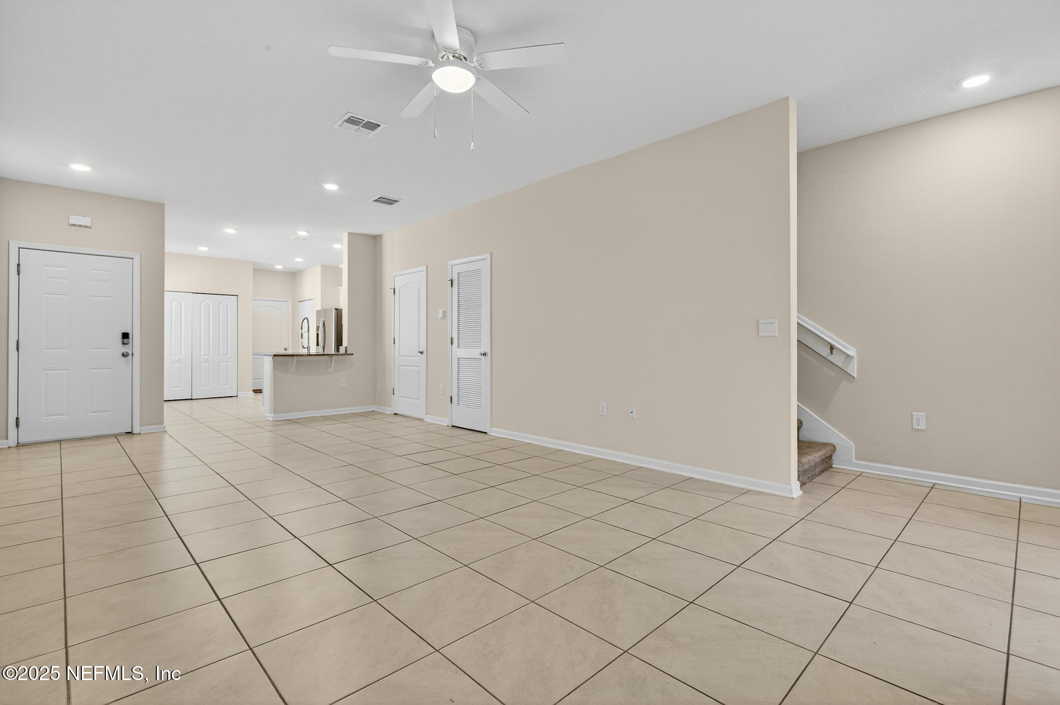 85 Talulla Trail St. Augustine, FL 32095 - Photo 55 of 55 an empty room with kitchen and chandelier fan