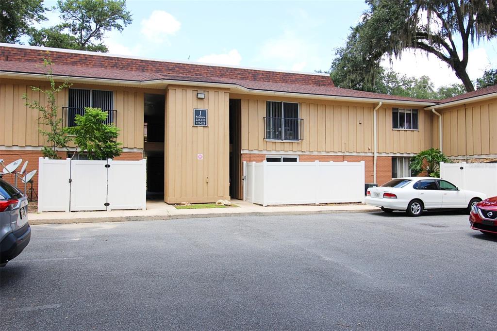 507 Northwest 39th Road, Unit 128 Gainesville, FL 32607 - Photo 1 of 1 a view of parking house and car parked in front of it