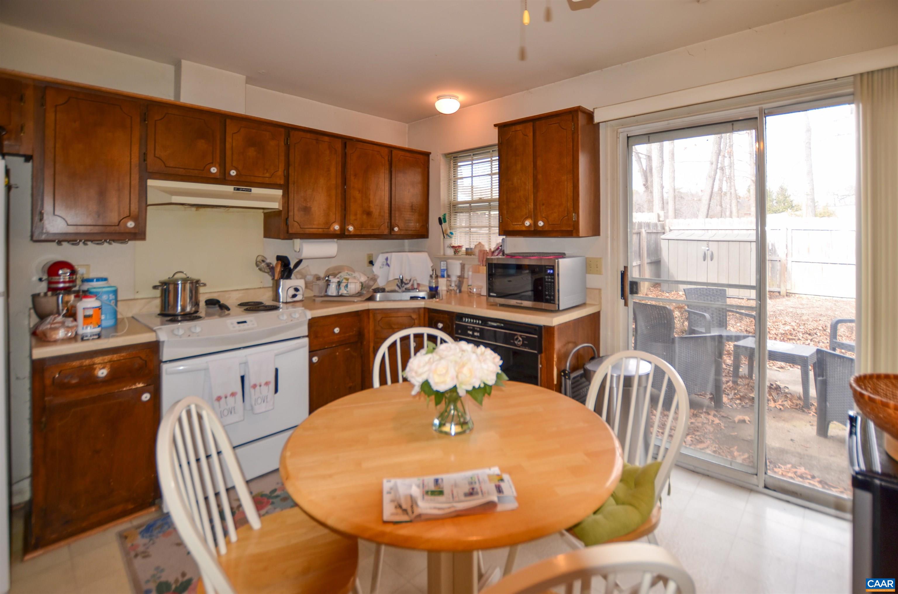 1594 Cool Spring Road Charlottesville, VA 22901 - Photo 10 of 26 a kitchen with a table chairs stove and cabinets