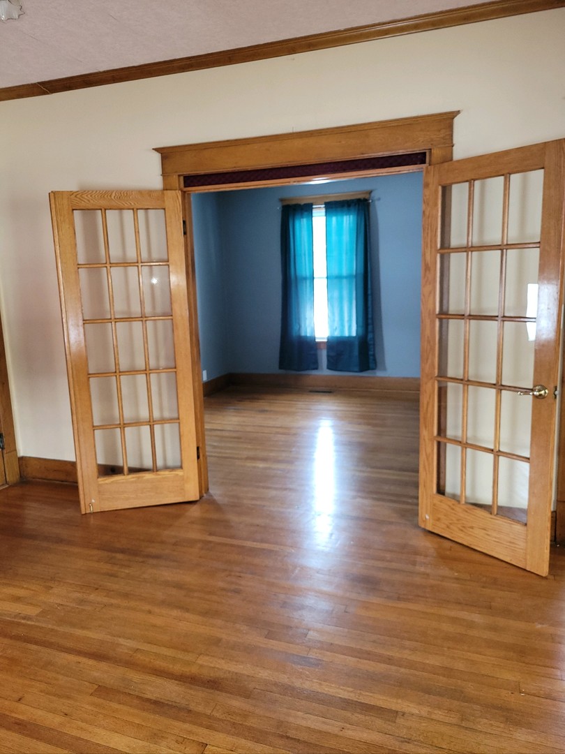23175 Litwiller Road Delavan, IL 61734 - Photo 13 of 37 a view of an empty room with wooden floor and a window
