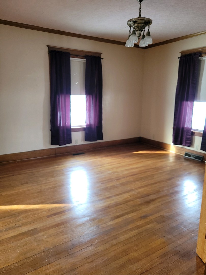 23175 Litwiller Road Delavan, IL 61734 - Photo 10 of 37 a view of an empty room with window and wooden floor