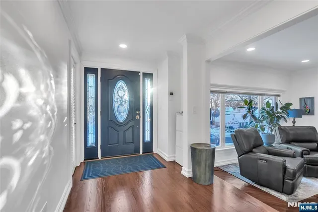 a view of a livingroom with wooden floor and stairs