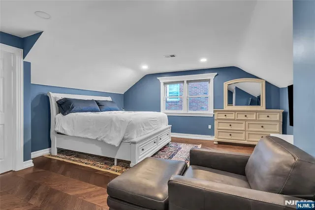 a bedroom with a bed and a fireplace