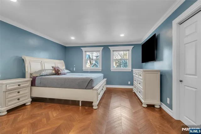 a spacious bedroom with a large bed and a dresser