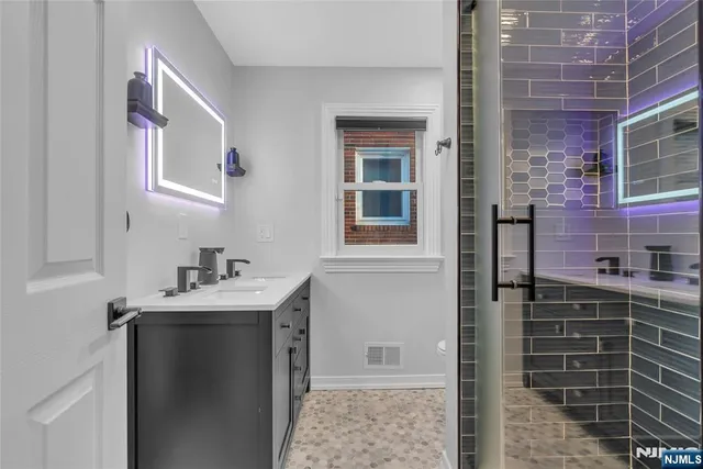 a bathroom with a sink a toilet and shower